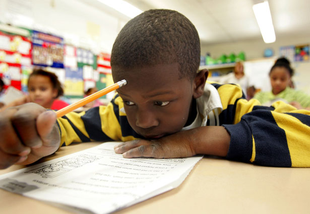 A student reads at a school in New Jersey. One in four black students were suspended in 2009-10, compared to one in fourteen white students. (AP Photo/Jose F. Moreno.)