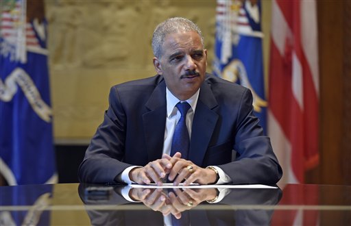 Attorney General Eric Holder speaks during an interview with The Associated Press at the Justice Department in Washington, Tuesday, Sept. 16, 2014. Broadening its push to improve police relations with minorities, the Justice Department has enlisted a team of criminal justice researchers to study racial bias in law enforcement in five American cities and recommend strategies to address the problem nationally, Holder said Tuesday. (AP Photo/Susan Walsh)