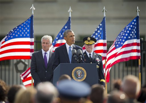 President Barack Obama, flanked by Defense Secretary Chuck Hagel, and Joint Chefs Chairman Gen. Martin Dempsey, speaks at the Pentagon, Thursday, Sept. 11, 2014, to mark the 13th anniversary of the 9/11 attacks. (AP Photo/Pablo Martinez Monsivais)