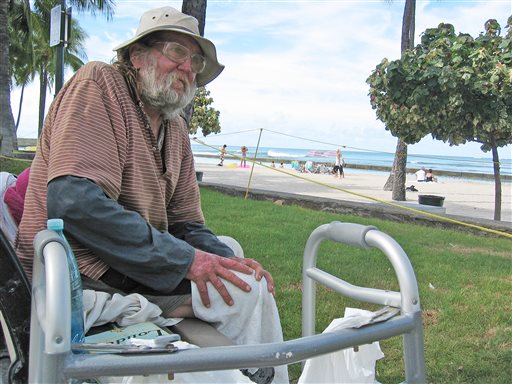 In this photo taken Monday Sept. 8, 2014, Jim Trevarthen, 62, watches the surfers near Waikiki Beach in Honolulu. Trevarthen is one of many homeless people who is unhappy with the city's proposals to ban sitting and lying down on sidewalks in the tourist mecca. Honolulu's city council is set to vote Wednesday on a sit-lie ban in Waikiki and Honolulu, aiming to keep homeless people out of sight after pressure from the tourism industry. (AP Photo/Cathy Bussewitz)