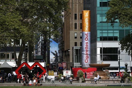 An inflatable cigarette is displayed to announce the drug store CVS' decision to stop selling cigarettes at its stores on Wednesday, Sept. 3, 2014, in New York. CVS announced Wednesday, Sept. 3, 2014 that it will tweak its corporate name. Rhode Island-based CVS Caremark will now be known as CVS Health, and stores will stop the sale of tobacco nearly a month sooner than planned. The cigars and cigarettes that used to fill the shelves behind store cash registers have been replaced with nicotine gum and other products that help people kick the tobacco habit. (AP Photo/Seth Wenig)