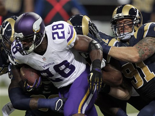 Minnesota Vikings running back Adrian Peterson (28) runs for a 5-yard gain as St. Louis Rams defensive end Chris Long, right, defends during the first quarter an NFL football game Sunday, Sept. 7, 2014, in St. Louis. (AP Photo/Tom Gannam)