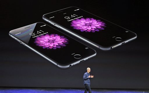 Apple CEO Tim Cook discusses the new iPhone 6 and iPhone 6 plus on Tuesday, Sept. 9, 2014, in Cupertino, Calif. The iPhone 6 will have a screen measuring 4.7 inches, while the iPhone 6 Plus will be 5.5 inches. (AP Photo/Marcio Jose Sanchez)