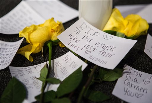 Messages of support on the stage near candles and flowers in between morning services at The Grove Church in Marysville, Wash., two days after the Marysville-Pilchuck High School shooting, on Sunday, Oct. 26, 2014. (AP Photo/The Seattle Times, Lindsey Wasson)