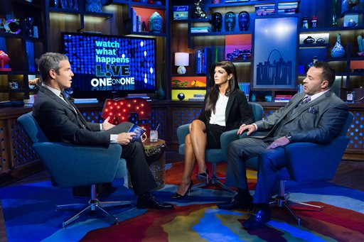 In this image released by Bravo shows host Andy Cohen, left, speaks with Teresa Giudice, and her husband Joe Giudice, cast members on "The Real Housewives of New Jersey," during a taping of "Watch What Happens Live," airing Monday, Oct. 6, 2014 on Bravo. Teresa was sentenced to 15 months in prison on conspiracy and bankruptcy charges and Joe was sentenced to 41 months last Thursday in federal court in Newark, N.J. (AP Photo/Bravo, Charles Sykes)