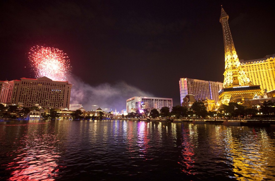 Light from Independence Day weekend fireworks is reflected in the water in front of the Bellagio Hotel in Las Vegas, July 3, 2011. (AP Photo)