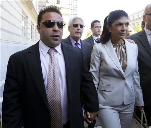 In this July 30, 2013 file photo, "The Real Housewives of New Jersey" stars Giuseppe "Joe" Giudice, 43, left, and his wife, Teresa Giudice, 41, of Montville Township, N.J., walk out of Martin Luther King, Jr. Courthouse after an appearance in Newark, N.J. Teresa and Giuseppe "Joe" Giudice are scheduled to be sentenced Thursday Oct. 2, 2014 on conspiracy and bankruptcy fraud charges in federal court in Newark. (AP Photo/Julio Cortez, File)