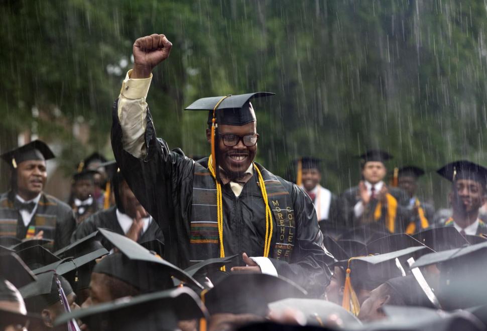 Graduate Frederick Anderson stands in the pouring rain as President Obama acknowledges him during his Morehouse College 129th Commencement ceremony address. (Carolyn Kaster/AP Photo)