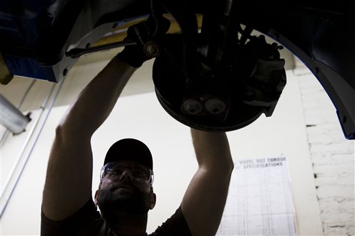In this Oct. 23, 2014 photo, an automotive service technology student works on a car at the Community College of Philadelphia Thursday, Oct. 23, 2014, in Philadelphia. The Labor Department releases employment data for October on Friday, Nov. 7, 2014. (AP Photo/Matt Rourke)