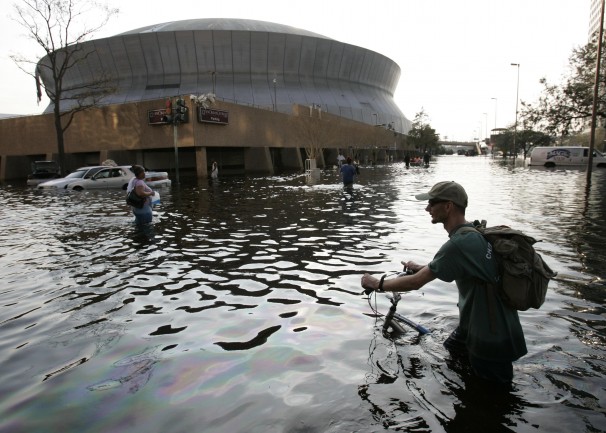 A man pushes his bicycle through flood waters near the Superdome in New Orleans on Aug. 31, 2005. (Eric Gay/AP Photo)