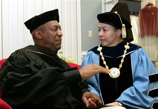 In this May 14, 2006 file photo, keynote speaker Bill Cosby, left, and Spelman College President Dr. Beverly Tatum talk before the start of commencement at the school in Atlanta. Cosbys legacy of giving is decades-old and extensive, topped by a $20 million gift to Spelman College in 1988 and including, among many other donations, $3 million to the Morehouse School of Medicine; $1 million in 2004 to the U.S. National Slavery Museum in Fredericksburg, Virginia; and $2 million from Cosby's wife, Camille, to St. Frances Academy in Baltimore in 2005. (AP Photo/W.A. Harewood, File)