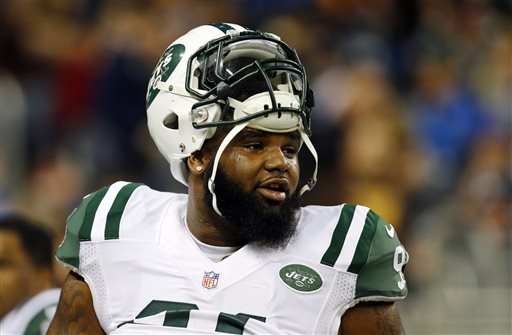 In this Nov. 24, 2014, file photo, New York Jets defensive end Sheldon Richardson watches during warmups before an NFL football game against the Buffalo Bills in Detroit. Richardson felt helpless as he watched the scenes near his hometown unfold on TV and social media. He was born and raised in St. Louis, just a few minutes away from the suburb of Ferguson, Mo., where police officer Darren Wilson was not indicted by a grand jury last week in the shooting death of Michael Brown. (AP Photo/Paul Sancya, File)