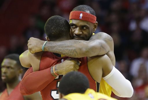 Cleveland Cavaliers forward LeBron James, right, hugs Miami Heat guard Dwyane Wade before an NBA basketball game, Thursday, Dec. 25, 2014, in Miami. (AP Photo/Lynne Sladky)