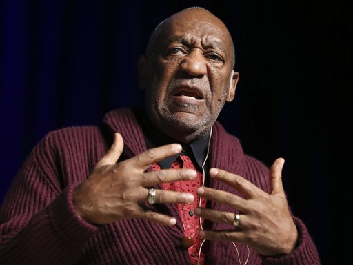 In this Nov. 6, 2013 file photo, comedian Bill Cosby performs at the Stand Up for Heroes event at Madison Square Garden in New York. Cosby resigned Monday, Dec. 1, 2014, as a trustee of Temple University following string of allegations that accused him of drugging and sexually assaulting women over many years. The 77-year-old entertainer has been a highly visible cheerleader of his beloved alma mater in Philadelphia and a board member since 198 (John Minchillo/Invision/AP, File)