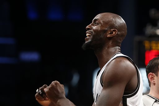 Brooklyn Nets' Kevin Garnett reacts after an altercation with Houston Rockets' Dwight Howard during the first quarter of an NBA basketball game Monday, Jan. 12, 2015, in New York.  Garnett was ejected from the game as a result of the incident. (AP Photo/Jason DeCrow)