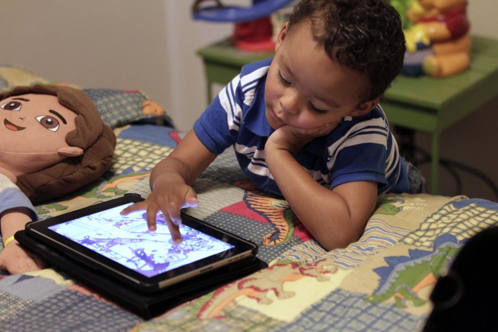 In this Friday, Oct. 21, 2011 photo, Frankie Thevenot, 3, plays with an iPad in his bedroom at his home in Metairie, La. About 40 percent of 2- to 4-year-olds (and 10 percent of kids younger than that) have used a smartphone, tablet or video iPod, according to a new study by the nonprofit group Common Sense Media. (AP Photo/Gerald Herbert)