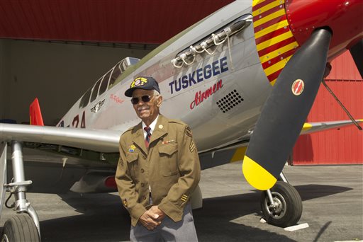 This April 7, 2011 photo by Bruce Talamon shows Clarence E. "Buddy" Huntley Jr., a member of the Tuskegee Airmen, the famed all-black squadron that flew in World War II, posing with a P-51C Mustang fighter plane similar to the one that he was a crew chief on while overseas during the war, at Torrance, Calif., Airport. Huntley and fellow Tuskegee Airman Joseph Shambrey, lifelong friends who enlisted together, both died on the same day, Monday, Jan. 5, 2015, in their Los Angeles homes, relatives said Sunday, Jan. 11, 2015. Both were 91. Huntley and Shambrey enlisted in 1942 and were shipped overseas to Italy in 1944 with the 100th Fighter Squadron of the Army Air Force's 332nd Fighter Group. As mechanics, they kept the combat planes flying. (AP Photo/Bruce Talamon (c) 2011 All Rights Reserved)