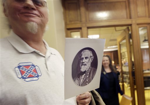 Dewey Spencer, of Judsonia, Ark., holds a portrait of Confederate Gen. Robert E. Lee after a meeting of the House Committee on State Agencies and Governmental Affairs, Wednesday, Jan. 28, 2015, at the State Capitol in Little Rock, Ark. A bid to end Arkansas' practice of commemorating Confederate Gen. Robert E. Lee and civil rights icon Martin Luther King Jr. on the same day has failed before a state House panel. (AP Photo/Danny Johnston)