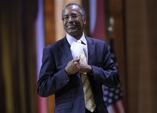 In this March 8, 2014 file photo, Dr. Ben Carson, professor emeritus at Johns Hopkins School of Medicine, puts his notes back in his pocket after speaking at the Conservative Political Action Committee annual conference in National Harbor, Md. Carsons publisher will review allegations that the conservative activist failed to properly credit sources in his 2012 book America the Beautiful. The allegations were raised by a BuzzFeed article that listed numerous examples of passages in Carsons book that closely resemble material which first appeared elsewhere. The book was co-written by Carsons wife, Candy Carson. (AP Photo/Susan Walsh, File)