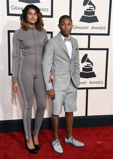Helen Lasichanh, left, and Pharrell Williams arrive at the 57th annual Grammy Awards at the Staples Center on Sunday, Feb. 8, 2015, in Los Angeles. (Photo by Jordan Strauss/Invision/AP)