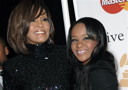 In this Feb. 12, 2011, file photo, singer Whitney Houston, left, and daughter Bobbi Kristina Brown arrive at an event in Beverly Hills, Calif. Messages of support were being offered Monday, Feb. 2, 2015, as people awaited word on Brown, who authorities say was found face down and unresponsive in a bathtub over the weekend in a suburban Atlanta home. (AP Photo/Dan Steinberg, File)