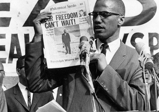 Black Muslim leader Malcolm X holds up a paper for the crowd to see during a Black Muslim rally in New York City on Aug. 6, 1963. (AP Photo)