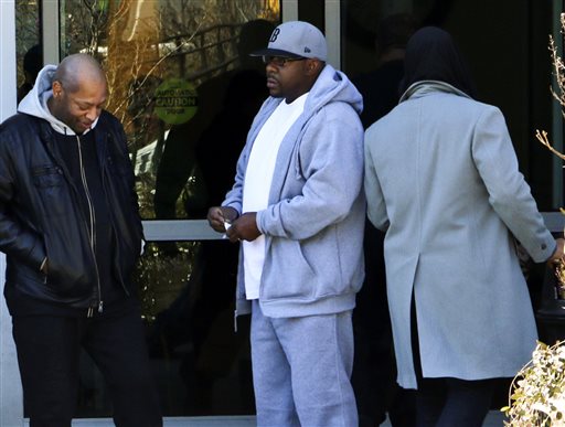 Entertainer Bobby Brown, center, stands outside of Emory Hospital in Atlanta where his daughter Bobbi Kristina Brown is being treated, Thursday, Feb. 5, 2015. Bobbi Kristina Brown, the only child of Bobby and the late Whitney Houston, has been hospitalized since Jan. 31 after being found unresponsive in a bathtub at a suburban Atlanta home. (AP Photo/Ron Harris)