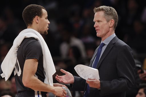 Golden State Warriors coach Steve Kerr, right, talks to Stephen Curry during the first half of an NBA basketball game against the New York Knicks on Saturday, Feb. 7, 2015, in New York. (AP Photo/Frank Franklin II)