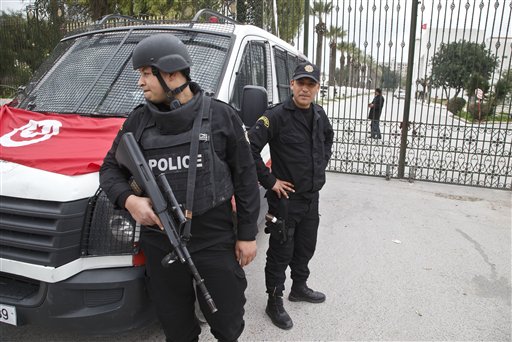 Tunisian police officers guard the entrance of the National Bardo museum in Tunis, Tunisia, Saturday March 21, 2015.  The two extremist gunmen who killed 21 people at a museum in Tunis trained in neighboring Libya before caring out the deadly attack, a top Tunisian security official said. (AP Photo/Michel Euler)
