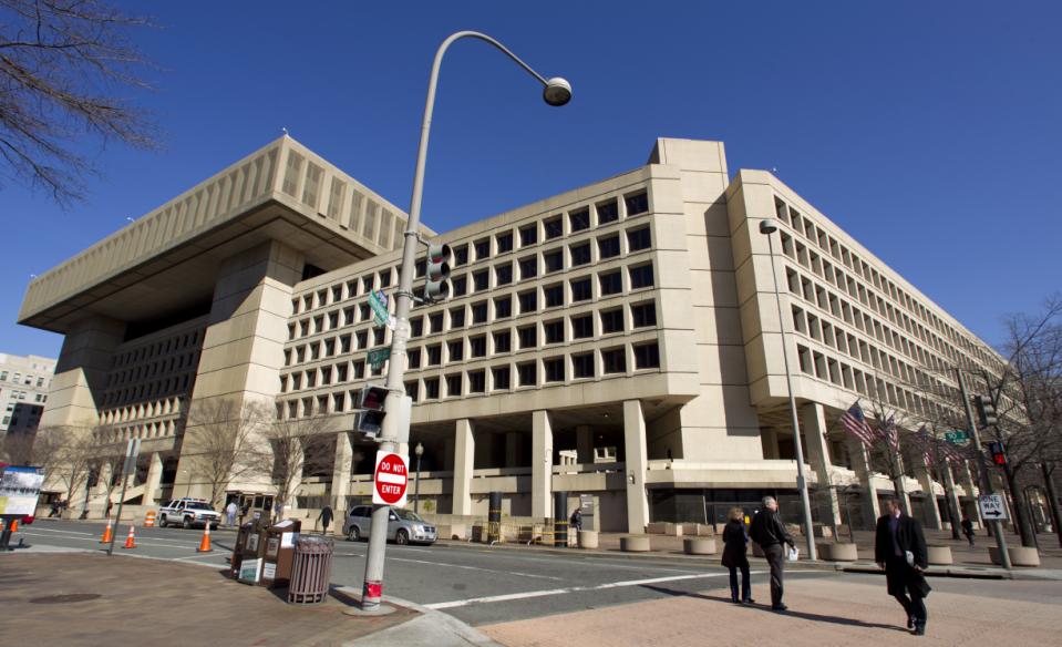 This Feb. 3, 2012 file photo shows Federal Bureau of Investigation (FBI) headquarters in Washington. Just six blocks from the White House, the FBI's hulking headquarters overlooking Pennsylvania Avenue has long been the government building everyone loves to hate. The verdict: it's an ugly, crumbling concrete behemoth. An architectural mishap, all 2.4 million square feet of it. But in this time of tight budgets, massive deficits and the "fiscal cliff," the 38-year-old FBI headquarters building has one big thing in its favor. It sits atop very valuable real estate, an entire city block on American's Main Street midway between the U.S. Capitol and the White House. Just how valuable, the General Services Administration intends to find out. (AP Photo/Manuel Balce Ceneta, File)