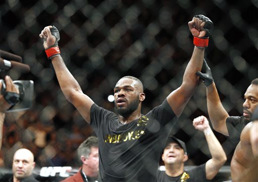 This Jan. 3, 2015, file photo shows Jon Jones celebrates after defeating Daniel Cormier during their light heavyweight title mixed martial arts bout in Las Vegas. Albuquerque police were searching for UFC light heavyweight champion Jones on Sunday night, April 26, 2015, in connection with a hit-and-run accident. Police spokesman Officer Simon Drobik said Jones is wanted for questioning about the crash, which occurred earlier in the day. No charges have been filed, but a pregnant woman driving another vehicle was hospitalized with minor injuries. (AP Photo/John Locher, File)