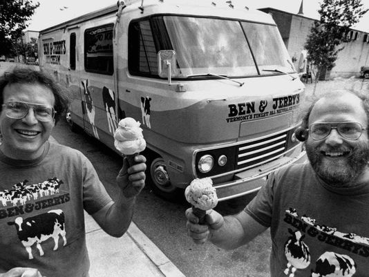 Jerry Greenfield, left, and Ben Cohen, founders of Ben & Jerry's Homemade Inc., stand in front of their "Scoopmobile" in Burlington, Vt. in 1986 . The founders of Ben & Jerry's Homemade Inc. say the company would not have existed without government resources that would be threatened if Congress repeals the estate tax. (Toby Talbot/AP Photo)