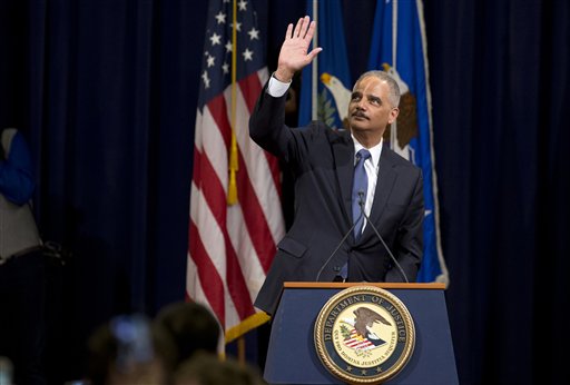 Attorney General Eric Holder waves to Justice Department during a farewell gathering at the Justice Department in Washington, Friday, April 24, 2015. Holder was bidding farewell to the Justice Department on Friday after six years as the nation's top law enforcement official. Holder was addressing employees at an afternoon ceremony one day after his chosen successor, Loretta Lynch, was confirmed by the Senate following a months-long delay.  (AP Photo/Manuel Balce Ceneta)