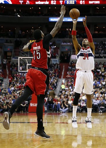 Washington Wizards forward Paul Pierce (34) shoots over Toronto Raptors forward Amir Johnson (15) in the second half of Game 4 in the first round of the NBA basketball playoffs, Sunday, April 26, 2015, in Washington. The Wizards won 125-94 to complete the first sweep of a seven-game series in club history, and advancing them to the second-round. (AP Photo/Alex Brandon)