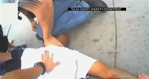 In this screen shot from April 2, 2015 video provided by the Tulsa County Sheriff's Office, police restrain 44-year-old Eric Harris after he was chased down and tackled by a Tulsa County Deputy, and then shot by a reserve sheriff's deputy while in custody, in Tulsa, Okla. The sheriff's office said 73-year-old reserve deputy Robert Charles Bates fired the shot that killed Harris, believing he was using his stun gun instead of his service weapon when he opened fire. (AP Photo/Tulsa County Sheriff's Office)