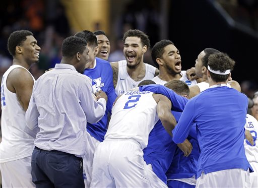 Kentucky players celebrate after a 68-66 win over Notre Dame in a college basketball game in the NCAA men's tournament regional finals, Saturday, March 28, 2015, in Cleveland. The 38-0 Wildcats advanced to the Final Four. (AP Photo/Tony Dejak)