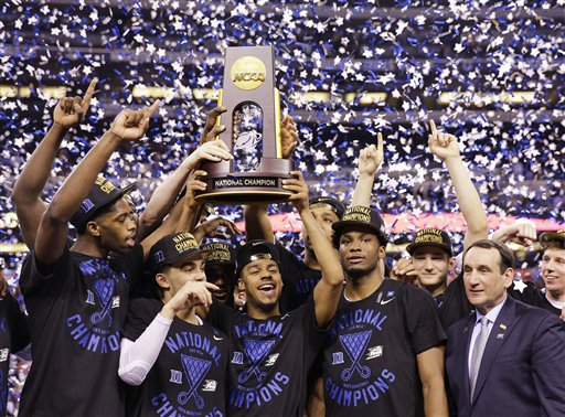 Duke players celebrate with the trophy after their 68-63 victory over Wisconsin in the NCAA Final Four college basketball tournament championship game Monday, April 6, 2015, in Indianapolis. (AP Photo/David J. Phillip)
