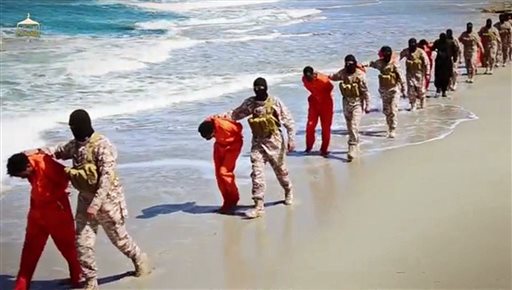 This undated image made from a video released by Islamic State militants, Sunday, April 19, 2015, shows a group of captured Ethiopian Christians taken to a beach before they were killed by Islamic State militants, in Libya.  The 29-minute video released online Sunday purportedly shows two groups of captives. It says one group is held by an IS affiliate in eastern Libya and the other by an affiliate in the south. A masked fighter delivers a long statement before the video switches between footage that purportedly shows the captives in the south being shot dead and the captives in the east being beheaded on a beach. (Militant video via AP)