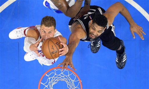 Los Angeles Clippers forward Blake Griffin, left, grabs a rebound away from San Antonio Spurs forward Tim Duncan during the first half of Game 5 of a first-round NBA basketball playoff series, Tuesday, April 28, 2015, in Los Angeles. (AP Photo/Mark J. Terrill)
