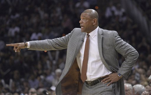 Los Angeles Clippers head coach Doc Rivers talks to his players during the first half of Game 6 in an NBA basketball first-round playoff series against the San Antonio Spurs, Thursday, April 30, 2015, in San Antonio. (AP Photo/Darren Abate)