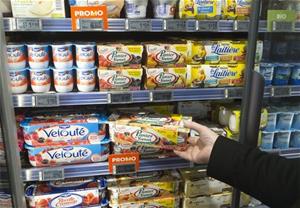 A man takes a yogurt pack from a refrigerator in a supermarket in Paris, March 12, 2015. (AP Photo/Michel Euler)