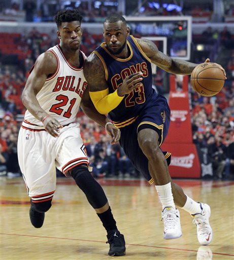 Cleveland Cavaliers forward LeBron James, right, drives past Chicago Bulls guard Jimmy Butler during the first half of Game 4 in a second-round NBA basketball playoff series in Chicago on Sunday, May 10, 2015. (AP Photo/Nam Y. Huh)