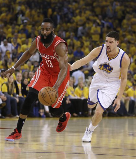 Houston Rockets' James Harden, left, drives the ball past Golden State Warriors' Klay Thompson (11) during the first quarter of Game 1 of the NBA basketball Western Conference finals Tuesday, May 19, 2015, in Oakland, Calif. (AP Photo/Ben Margot)