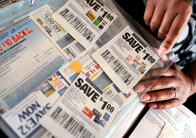 Delly Mellor, of Delly's Deals, thumbs through a binder full of coupons that she carries on her grocery shopping trips at her home in Wilmington, N.C., in this photo from April 5. Mellor operates dellysdeals.com with a coupon database and information on couponing workshops. Although you should look through the Sunday newspaper coupon inserts, most coupons can be found online. (Mike Spencer/The Star-News, via AP)