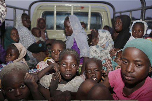 In this Saturday May 2, 2015 file photo, women and children rescued by Nigeria soldiers from Islamist extremists at Sambisa forest arrive at a camp for the displaced people in Yola, Nigeria. All 275 women, girls and children rescued from Boko Haram and taken to the safety of a northeast Nigerian refugee camp have been taken into military custody amid suspicions that some are aiding the Islamic extremists, a camp official and a Nigerian military intelligence officer said Wednesday May 20, 2015. (AP Photo/Sunday Alamba File)