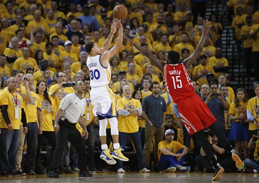 Golden State Warriors guard Stephen Curry (30) shoots against Houston Rockets center Clint Capela (15) during the first half of Game 1 of the NBA basketball Western Conference finals in Oakland, Calif., Tuesday, May 19, 2015. (AP Photo/Tony Avelar)