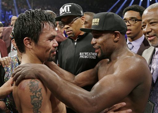 This May 2, 2015 file photo shows Manny Pacquiao, from the Philippines, left, and Floyd Mayweather Jr., embrace in the ring at the finish of their welterweight title fight in Las Vegas. Boxing fans across the country or at least their lawyers are calling the hyped-up fight between Pacquiao and Mayweather a fraud. Some 31 class action lawsuits had been filed through Friday alleging primarily the same thing: that Pacquiaos pre-existing shoulder injury should have been disclosed to fans ahead of time. (AP Photo/Isaac Brekken, File)