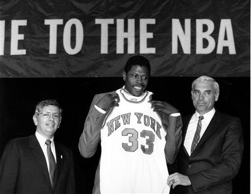 In this June 18, 1985, file photo, Patrick Ewing accepts his New York Knicks jersey from Dave DeBusschere, right, general manager of the Knicks, as NBA commissioner David Stern look on, at the NBA Draft in New York. The NBA draft lottery debuted 30 years ago. The 2015 NBA draft lottery will take place in New York on Tuesday, May 19, 2015. (AP Photo/Marty Lederhandler, File)