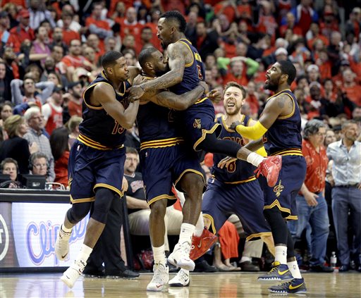 Cleveland Cavaliers' LeBron James, second from left, celebrates with Tristan Thompson, left, J.R. Smith, center, Matthew Dellavedova, and Kyrie Irving, right, after scoring the game-winning basket during the second half of Game 4 in a second-round NBA basketball playoff series against the Chicago Bulls in Chicago on Sunday, May 10, 2015. The Cavaliers won 86-84. (AP Photo/Nam Y. Huh)
