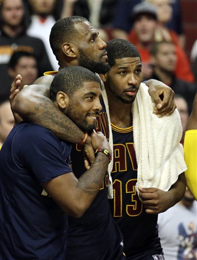 Cleveland Cavaliers forward LeBron James, center, watches the end of the game against the Chicago Bulls with guard Kyrie Irving, left, and center Tristan Thompson during the second half of Game 6 in a second-round NBA basketball playoff series in Chicago on Thursday, May 14, 2015. The Cavaliers won 94-73. (AP Photo/Nam Y. Huh)